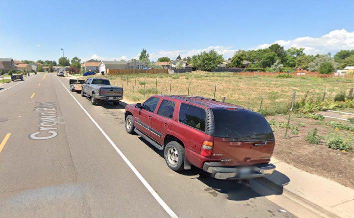 Photograph of cars parked on road